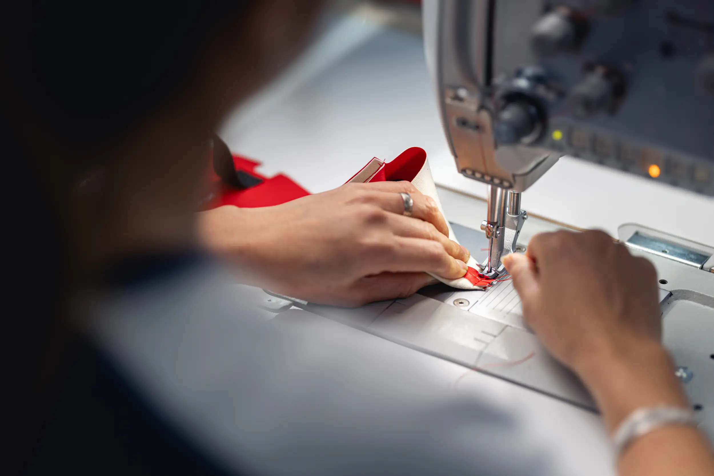 An employee is working with a sewing machine