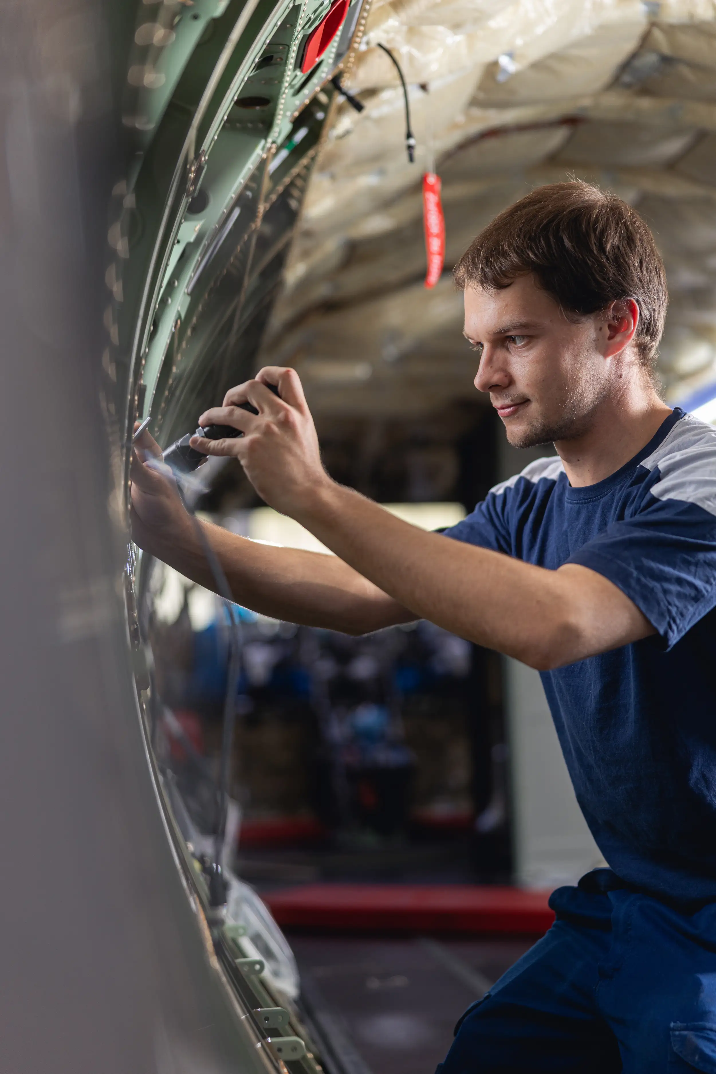 An employee is working on the aircraft