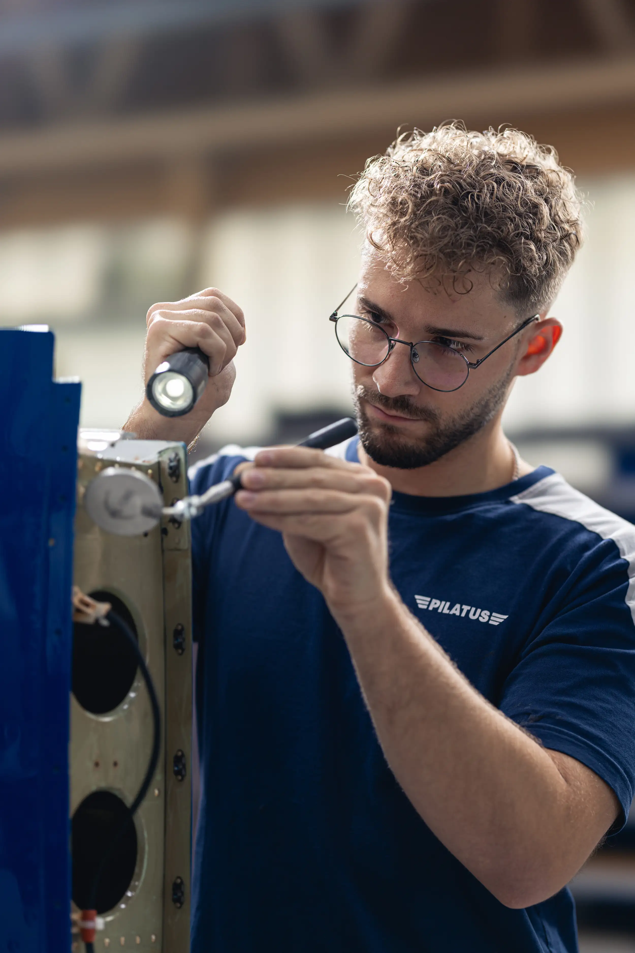 An employee is working on the aircraft